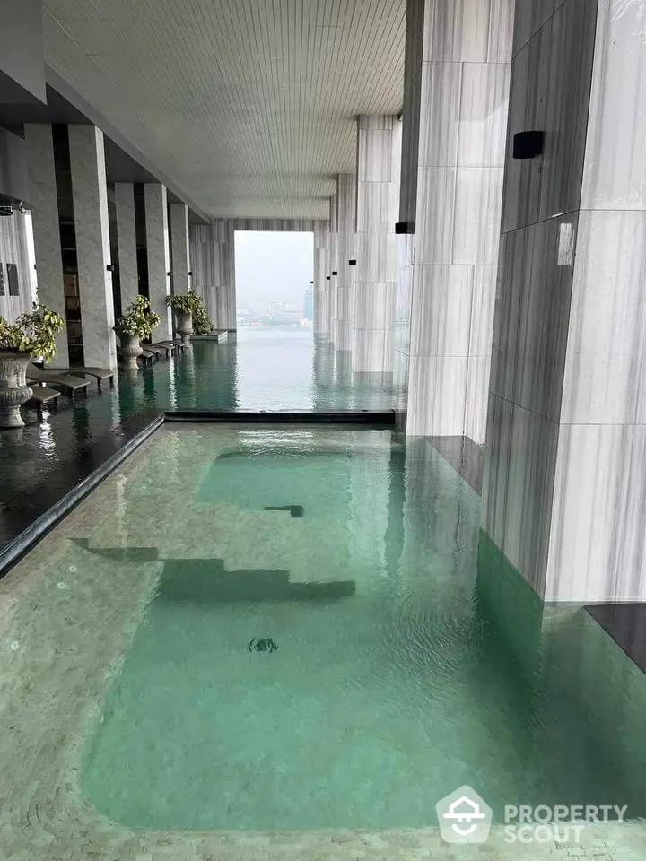 Luxurious indoor pool with panoramic city views in modern high-rise building