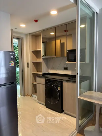 Modern kitchen with sleek appliances and open layout in a stylish apartment.