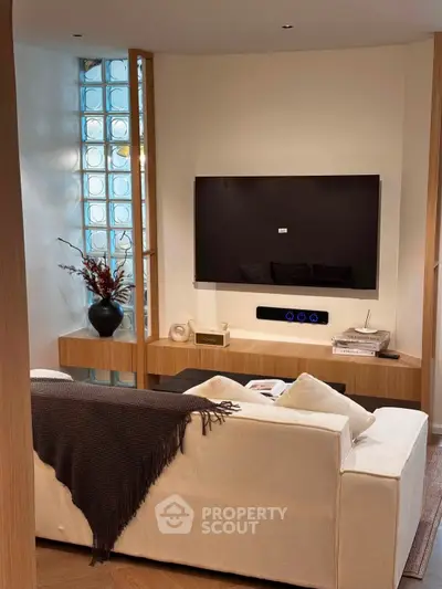 Modern living room with sleek TV setup and cozy seating area