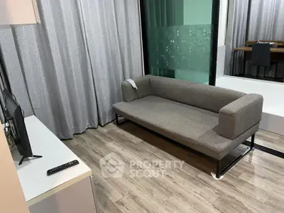 Modern living room with sleek gray sofa and stylish decor