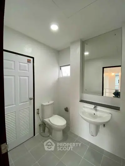 Modern bathroom with sleek fixtures and bright lighting in a contemporary home.