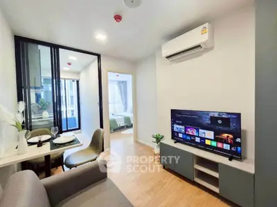 Modern living room with open layout, stylish furniture, and natural light in a contemporary apartment.