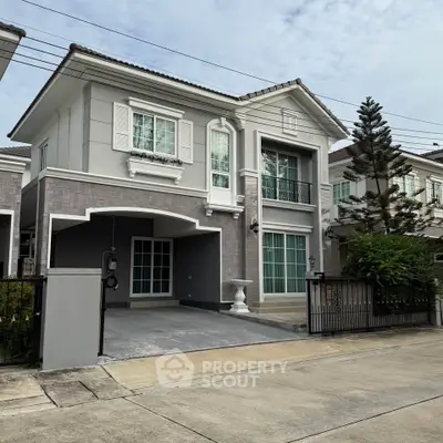 Elegant two-story house with modern design and spacious driveway in a serene neighborhood.