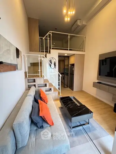 Modern living room with loft, stylish decor, and open layout