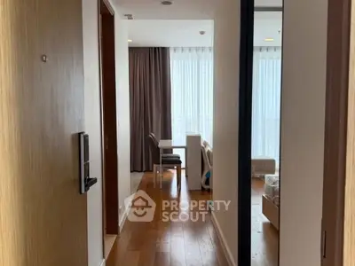 Cozy apartment hallway leading to a bright bedroom with modern furnishings.