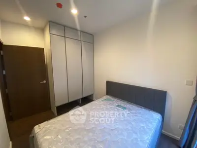 Modern bedroom with sleek wardrobe and comfortable bed in a cozy apartment.