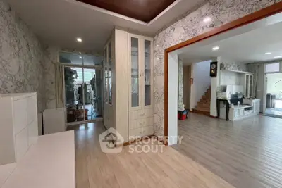 Spacious open-plan living area with elegant wood flooring and modern decor.
