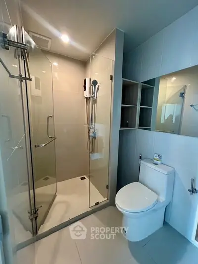 Modern bathroom with glass shower enclosure and sleek fixtures