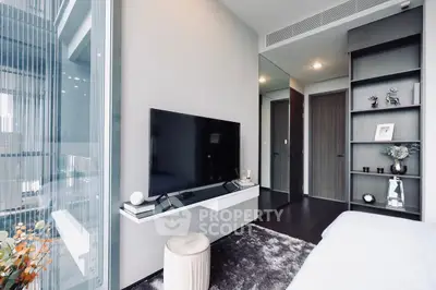 Modern bedroom with sleek TV setup and floor-to-ceiling windows