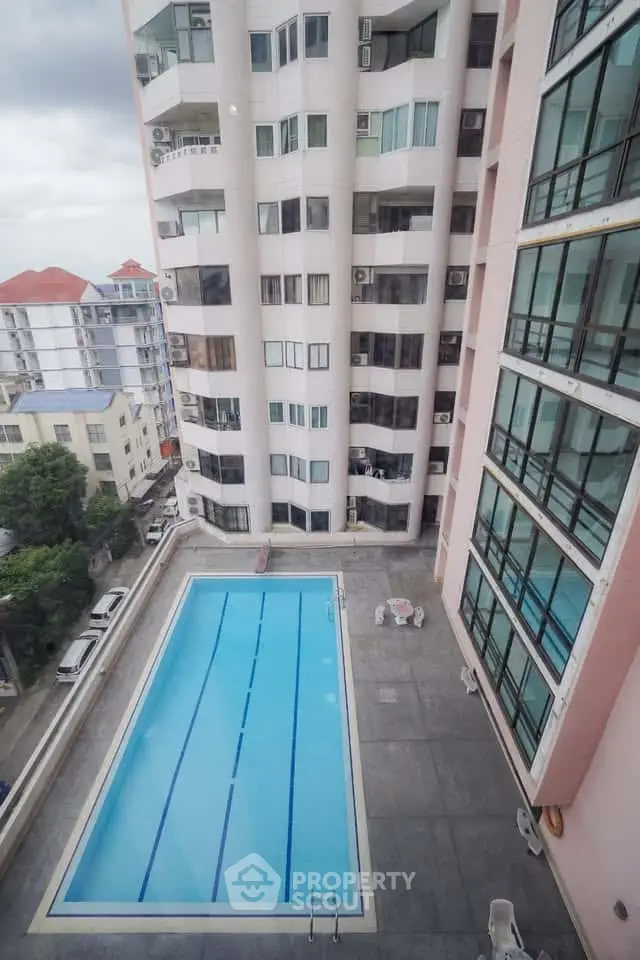 High-rise building with a rooftop pool offering a stunning urban view.