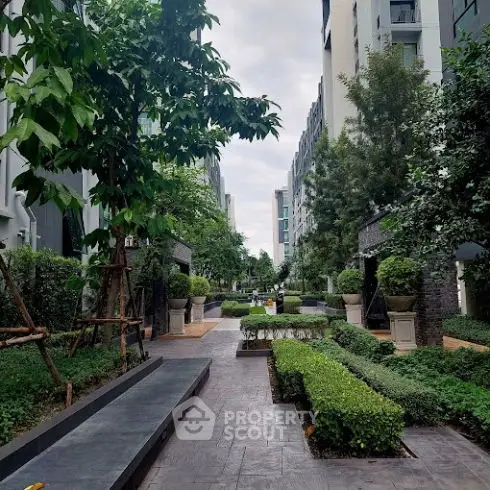Luxurious garden pathway in modern residential complex with lush greenery