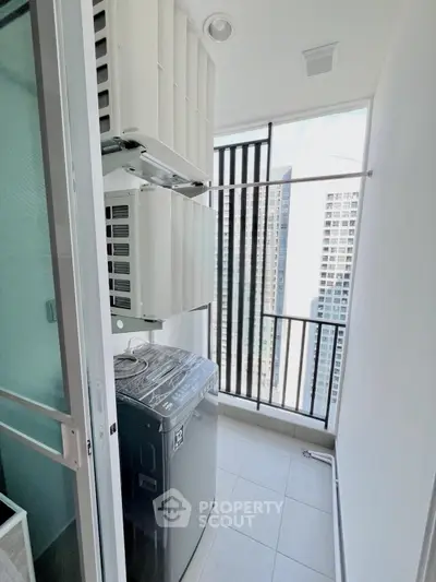 Modern apartment balcony with washing machine and city view