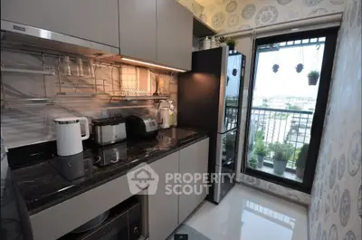 Modern kitchen with sleek appliances and balcony view, featuring stylish decor and efficient layout.