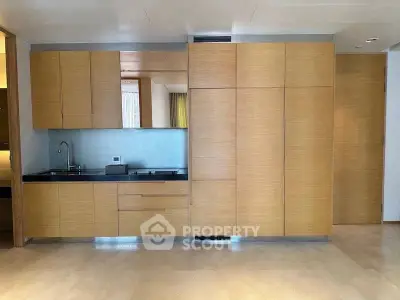 Modern kitchen with sleek wooden cabinetry and integrated appliances
