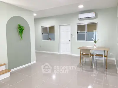Modern minimalist living space with sleek tile flooring and stylish dining area.