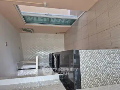 Modern bathroom with sleek tile design and skylight feature