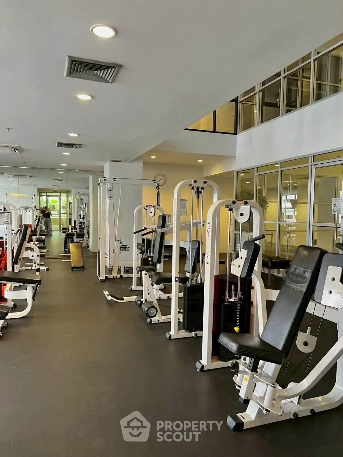 Spacious modern gym with state-of-the-art fitness equipment in a residential building.