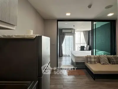 Modern apartment interior with open layout, featuring a cozy living area and a stylish bedroom with large windows.
