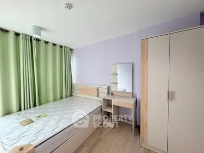 Spacious bedroom with modern furniture and natural light