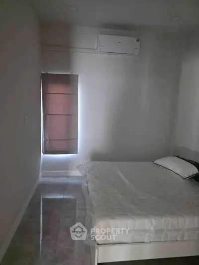 Cozy bedroom with air conditioning and natural light, perfect for restful nights.
