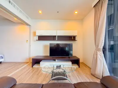 Modern living room with sleek TV unit and glass coffee table