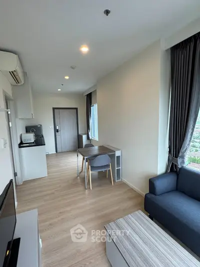 Modern living room with sleek furniture and natural light in a stylish apartment.