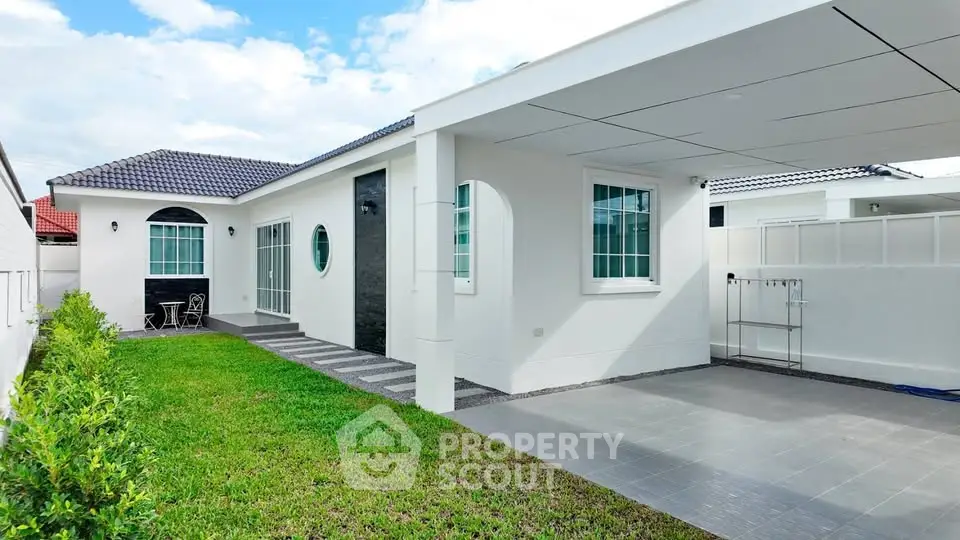 Charming single-story home with modern exterior and spacious carport in a serene neighborhood.