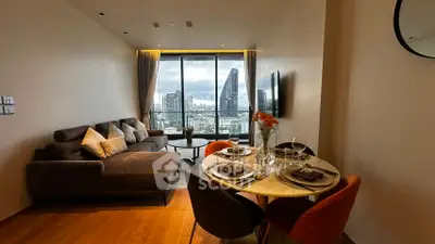 Modern living room with city view, stylish furniture, and dining area in a high-rise apartment.