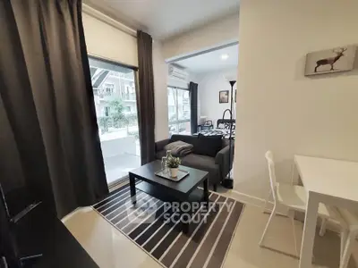 Modern living room with stylish decor and large windows in a cozy apartment.