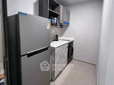 Modern compact kitchen with sleek appliances and stylish cabinetry