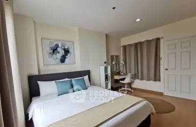 Spacious bedroom with modern decor and study area, perfect for comfort and productivity.