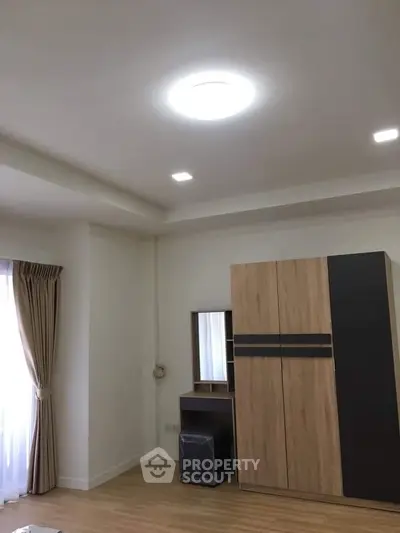 Spacious bedroom with modern wardrobe and natural light