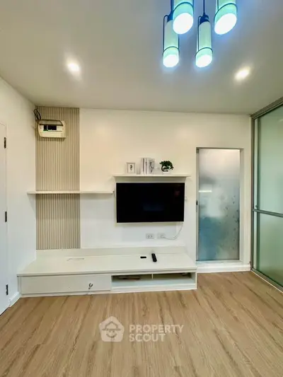 Modern living room with sleek TV setup and stylish lighting
