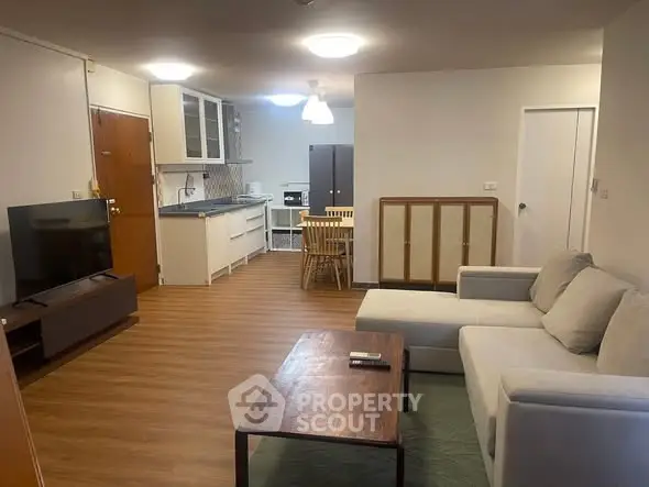 Spacious open-plan living room with modern kitchen and cozy seating area.
