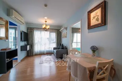 Charming living room with elegant decor, cozy seating, and natural light in a modern apartment.