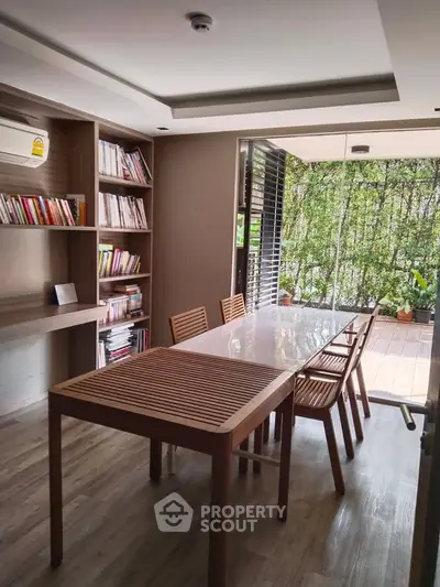 Charming study room with wooden furniture and garden view, perfect for work or relaxation.