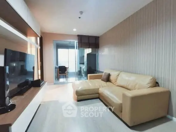 Modern living room with beige leather sofa and sleek entertainment unit