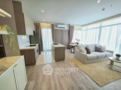 Spacious modern living room with open kitchen and large windows