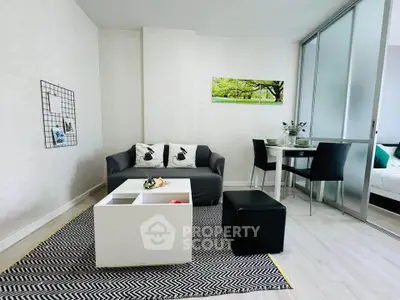 Modern living room with stylish decor and dining area in open layout apartment.