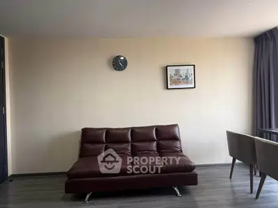 Modern living room with sleek brown sofa and minimalist decor