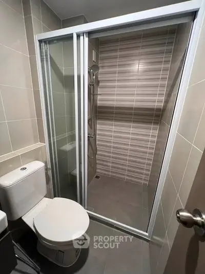 Modern bathroom with sleek shower enclosure and contemporary tiles