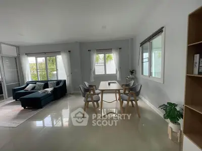 Spacious modern living room with dining area and natural light
