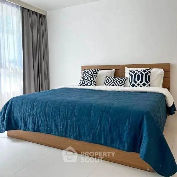 Spacious bedroom with modern decor and natural light