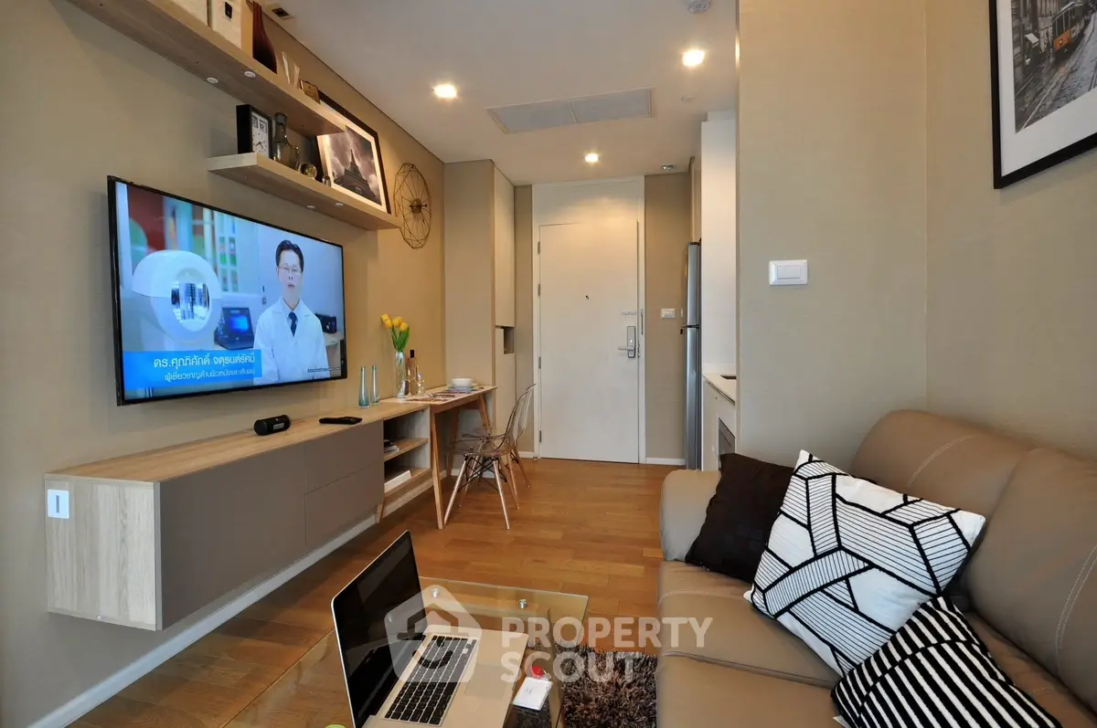 Modern living room with sleek furniture and wall-mounted TV, perfect for urban lifestyle.