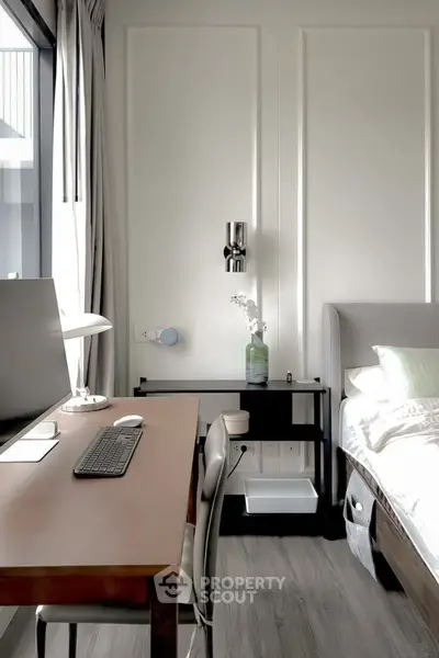 Modern bedroom with study area, featuring sleek desk and comfortable bed in bright, minimalist design.