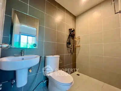 Modern bathroom with sleek fixtures and tiled walls in a contemporary home.