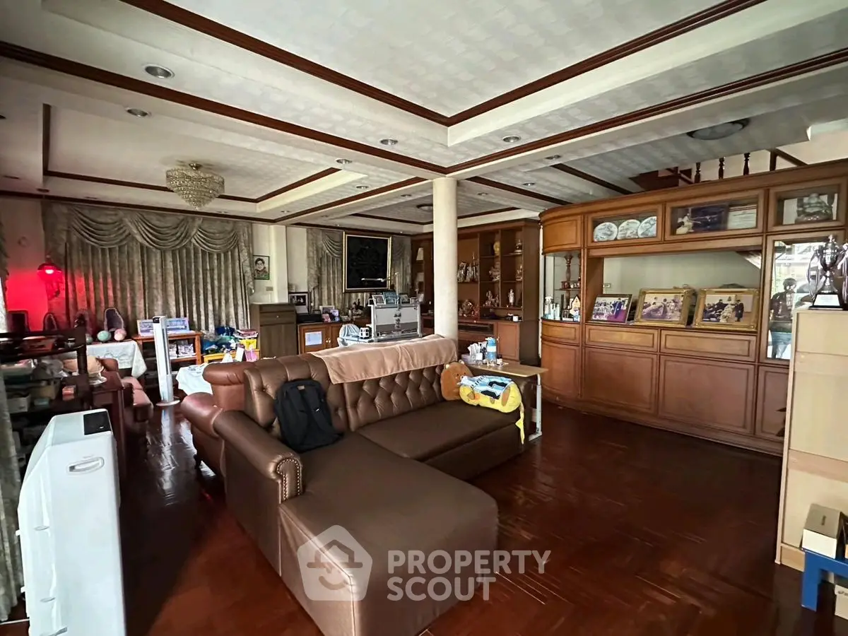 Spacious living room with elegant wooden flooring and classic furnishings.
