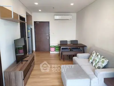 Modern living room with stylish furniture and wooden flooring in a cozy apartment.