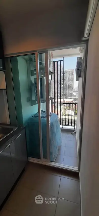 Modern apartment balcony with city view and laundry area