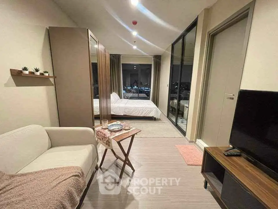 Modern studio apartment with cozy living area and city view